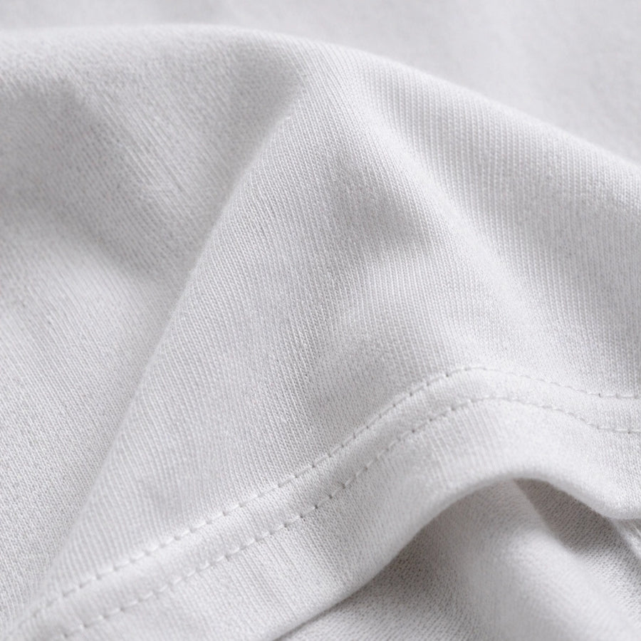 Close-up of white fabric with visible stitching