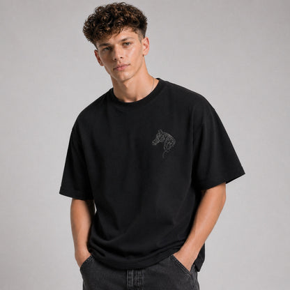 Person wearing a black t-shirt with a graphic design on a gray background