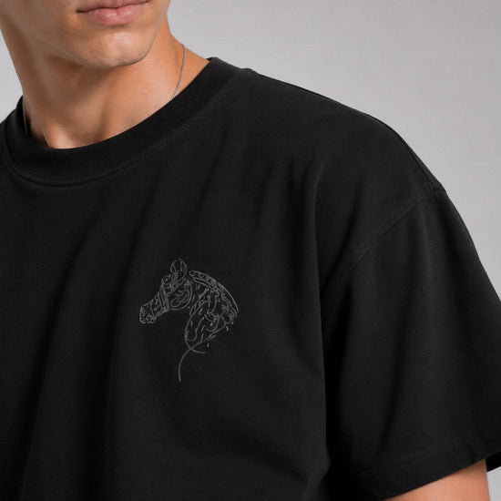 Black t-shirt with a horse head design on a gray background