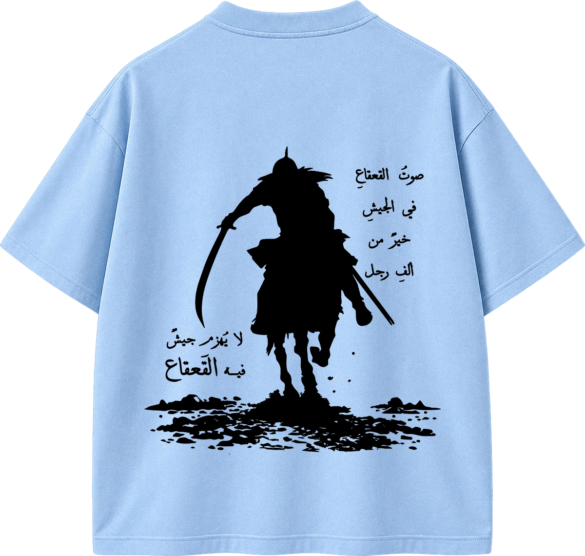A light blue short-sleeve T-shirt shown from the back, featuring a large black graphic of a silhouetted rider on horseback with Arabic text printed around it.