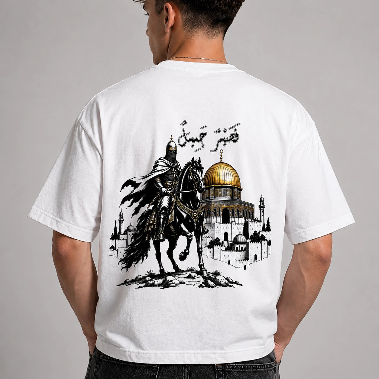 White t-shirt with a graphic design of a horse and architectural elements on the back, worn by a person.