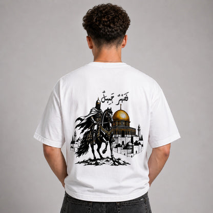 Person wearing a white t-shirt with a graphic design on the back, featuring a horse and a dome.