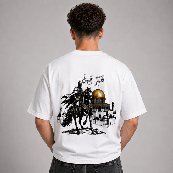 Person wearing a white t-shirt with a graphic design on the back, featuring a horse and a dome.