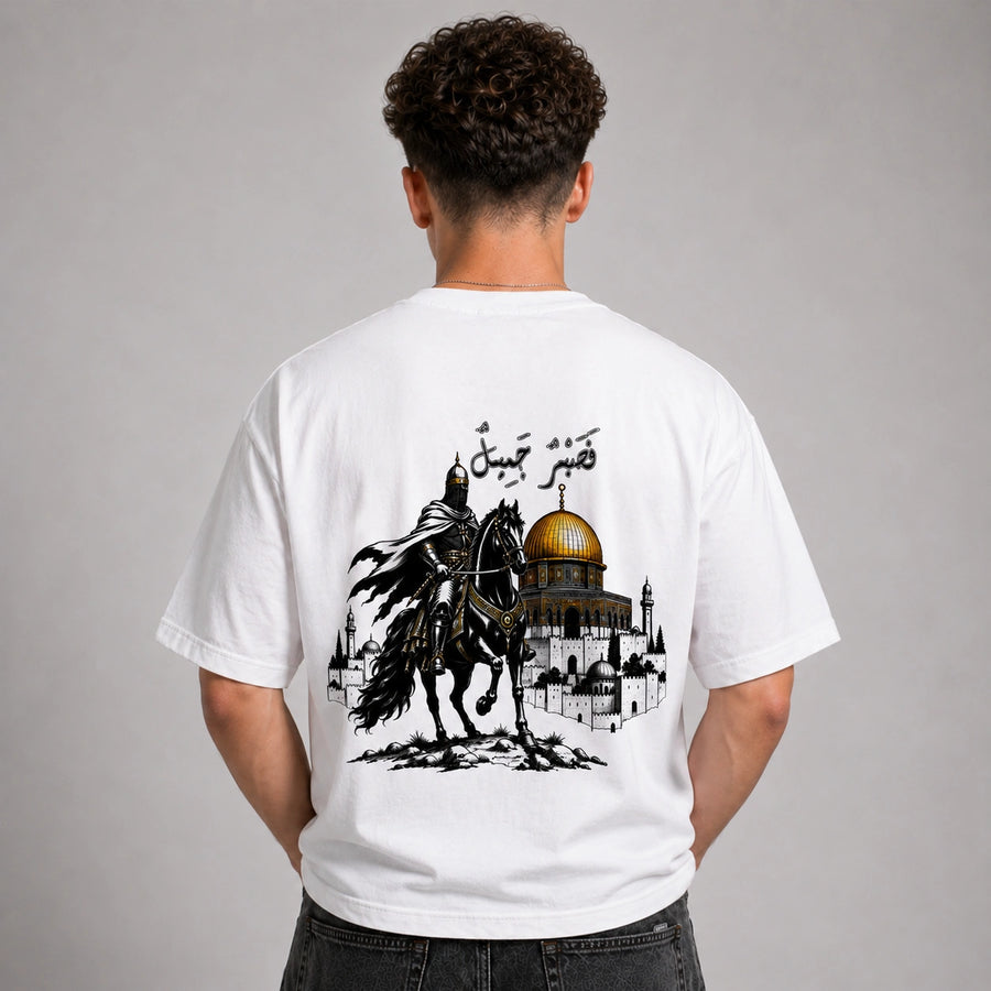 Person wearing a white t-shirt with a graphic design on the back, featuring a horse and a dome.