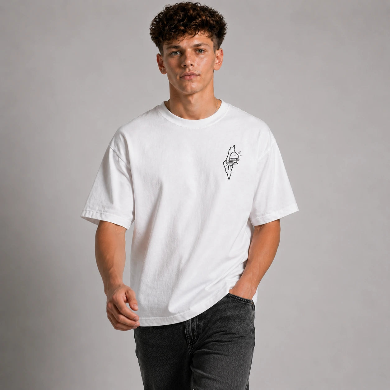Person wearing a white t-shirt with a small design on a plain background