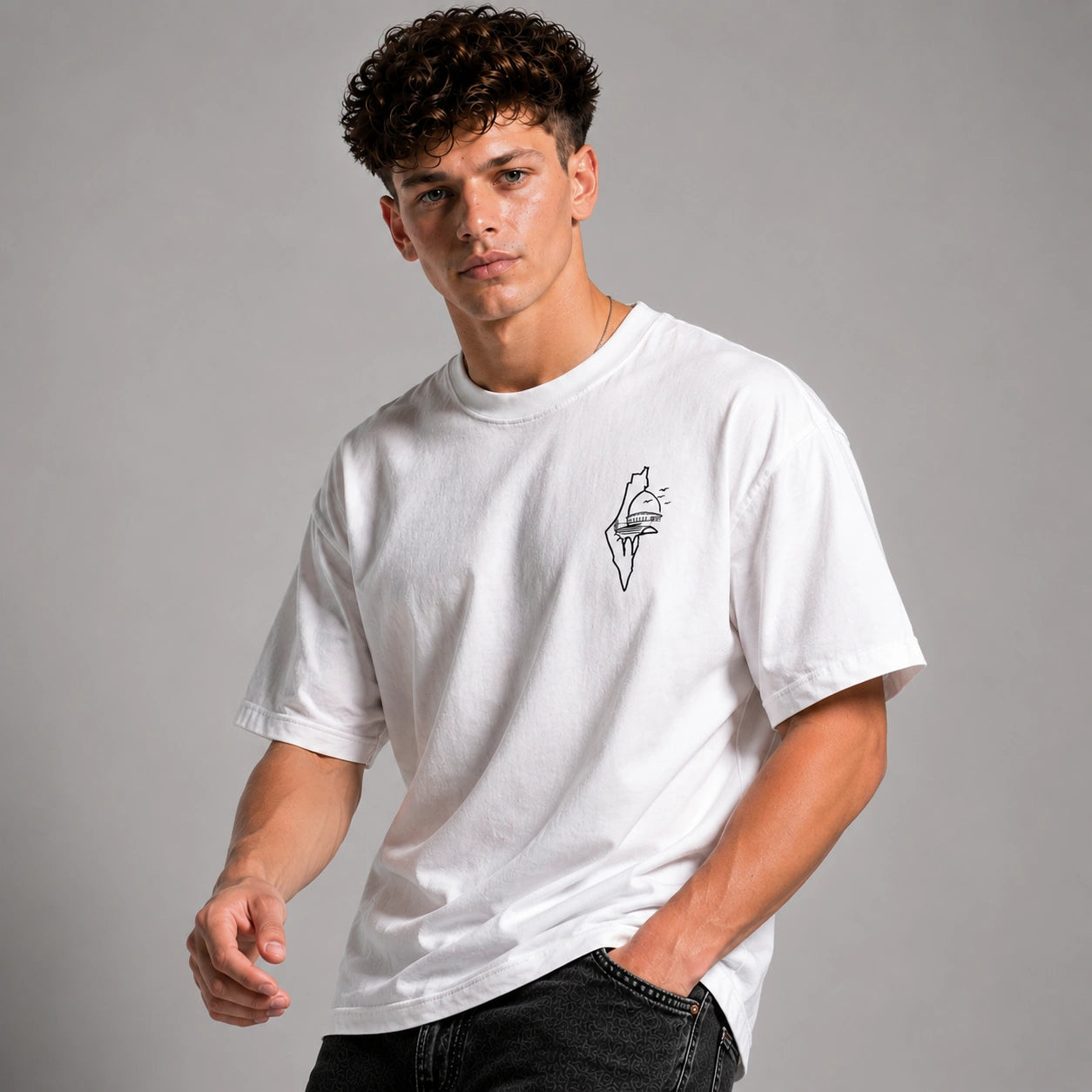 Man wearing a white t-shirt with a small graphic on a gray background