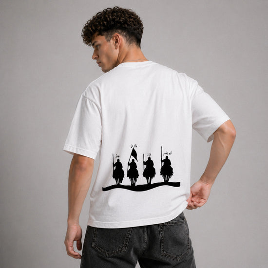 Person wearing a white t-shirt with black graphic design on the back against a gray background