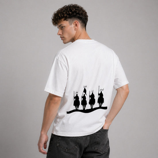 Person wearing a white t-shirt with black graphic design on the back, standing against a gray background
