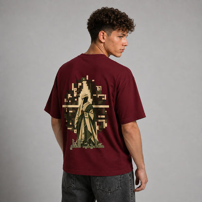 A man wearing a maroon t-shirt with a large graphic print on the back, shown from behind against a neutral gray studio background.