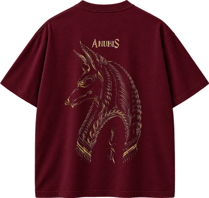 A maroon short-sleeve t-shirt shown from the back, featuring a large gold-toned graphic of the Anubis horse head with the word 'ANUBIS' printed above it.
