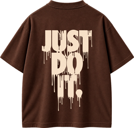 A brown short-sleeve t-shirt shown from the back, featuring a large cream-colored dripping text graphic that reads 'JUST DO IT.' on the back.