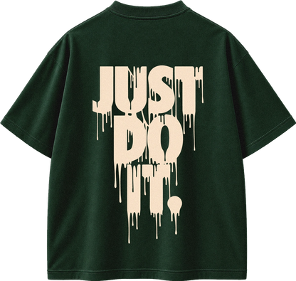 A dark forest green short-sleeve t-shirt shown from the back, featuring a large cream-colored dripping text graphic that reads 'JUST DO IT.' on the back.