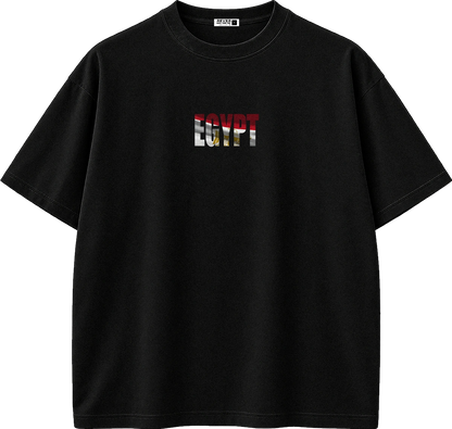 A black short-sleeve crewneck t-shirt featuring a chest graphic that reads 'EGYPT' in a distressed flag pattern of red, white, black, and gold. The shirt is displayed flat against a solid white background.
