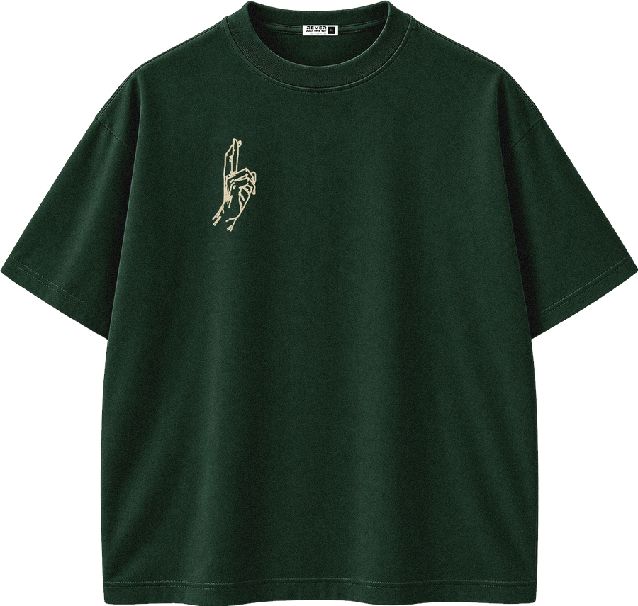 A dark forest green short-sleeve crewneck t-shirt with a small beige graphic of two hands holding a small object on the left chest, displayed on a clean white background.