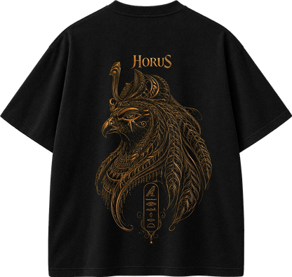 A black short-sleeve T-shirt shown flat against a white background, featuring a large ornate gold graphic of a bird head with feather-like details and the word "HORUS" printed above it.