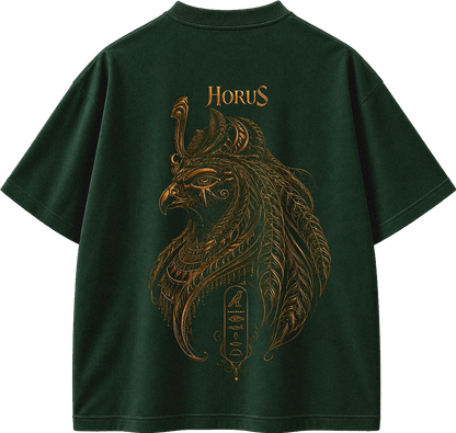 A dark forest green t-shirt shown from the back, featuring a large gold-colored graphic of Horus with Egyptian-inspired feather and serpent details, and the word 'HORUS' printed above.