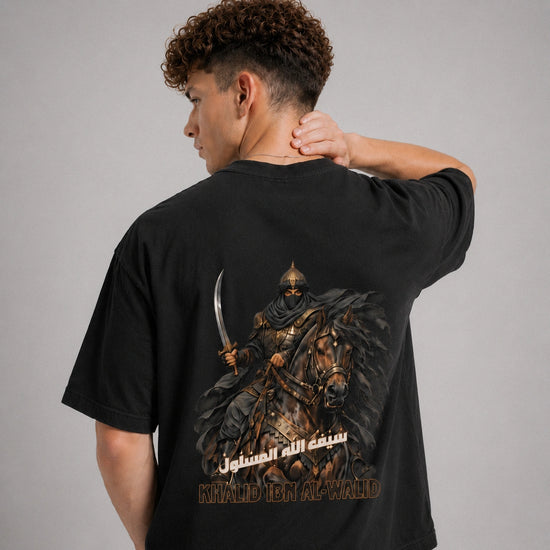 Person wearing a black t-shirt with a graphic design on the back, featuring a warrior on a horse.
