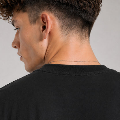 Person wearing a black shirt with a neutral background