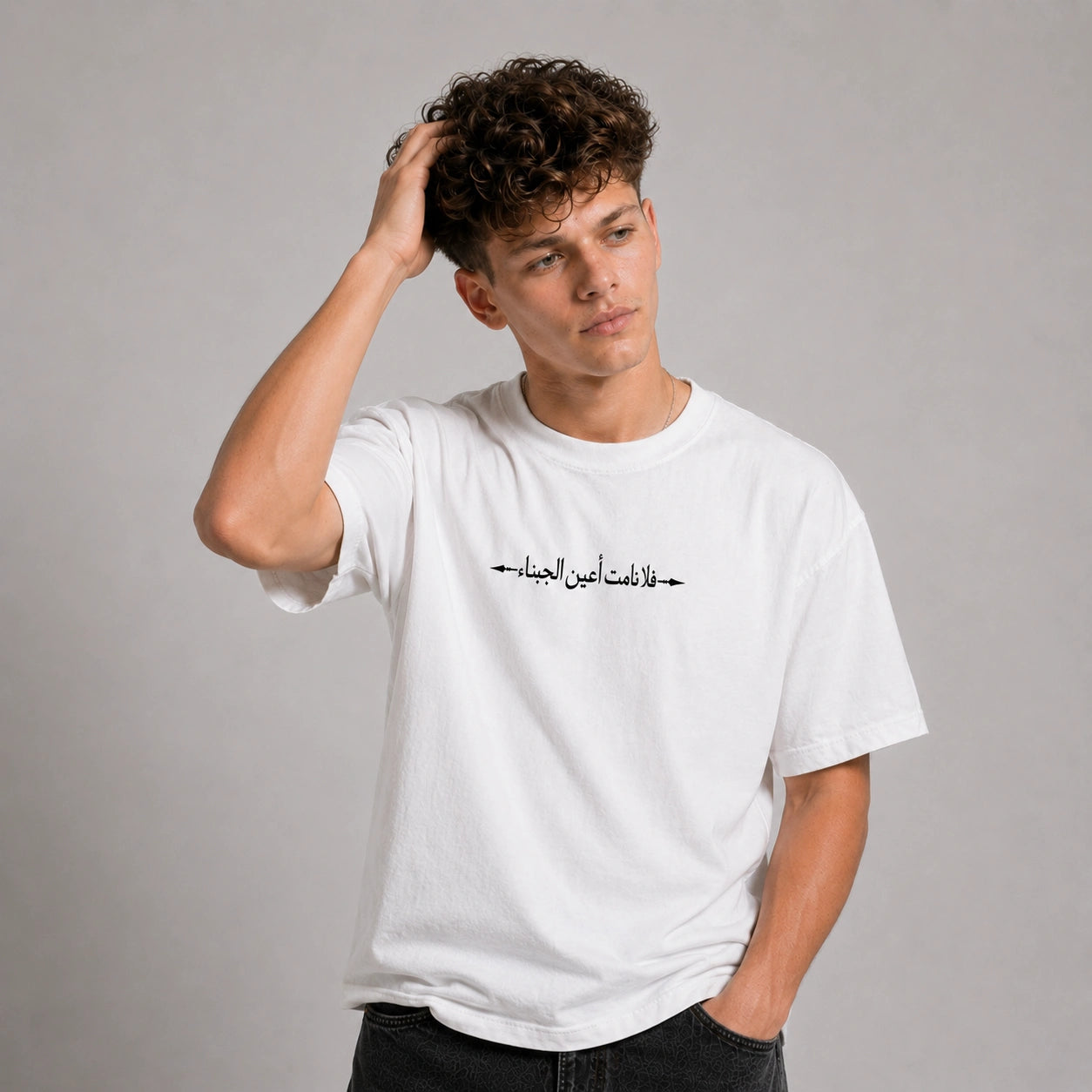 Person wearing a black t-shirt with a graphic design on the back against a gray background