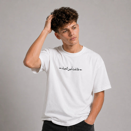 Person wearing a black t-shirt with a graphic design on the back against a gray background