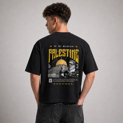 Person wearing a black t-shirt with a graphic design on the back, featuring text and images.