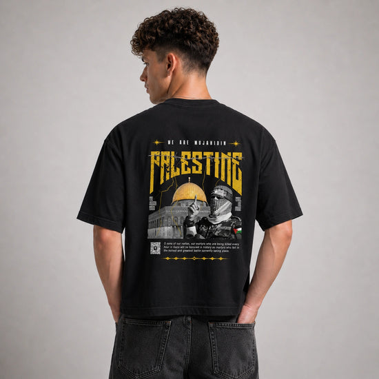 Person wearing a black t-shirt with a graphic design on the back, featuring text and images.