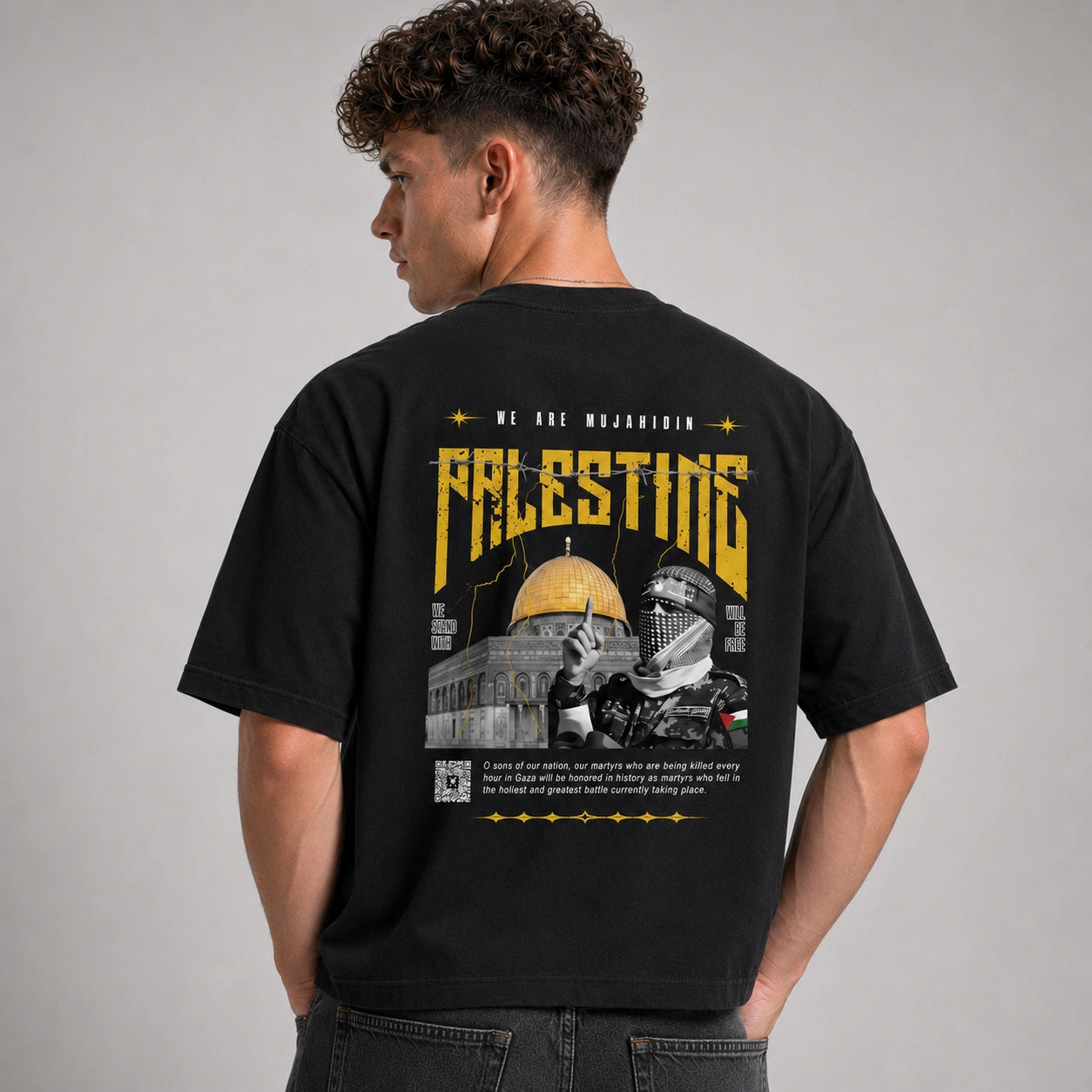 Person wearing a black t-shirt with a graphic design on the back, featuring text and images.
