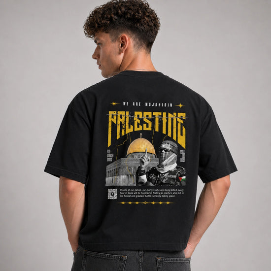 Person wearing a black t-shirt with a graphic design on the back, featuring text and images.