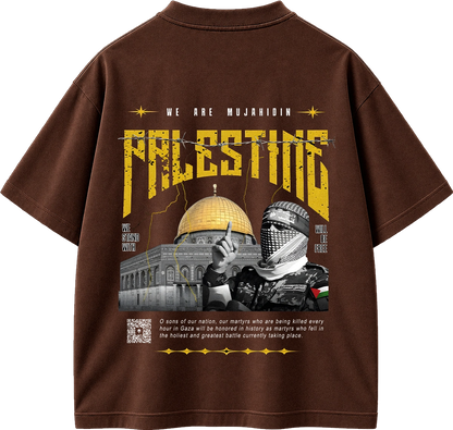 A brown short-sleeve graphic T-shirt shown from the back, featuring a large distressed yellow 'PALESTINE' print, the text 'WE ARE MUJAHIDIN', a dome of the rock illustration, and a black-and-white image of a kuffiyeh-wearing figure. The shirt is photographed on a plain white background.