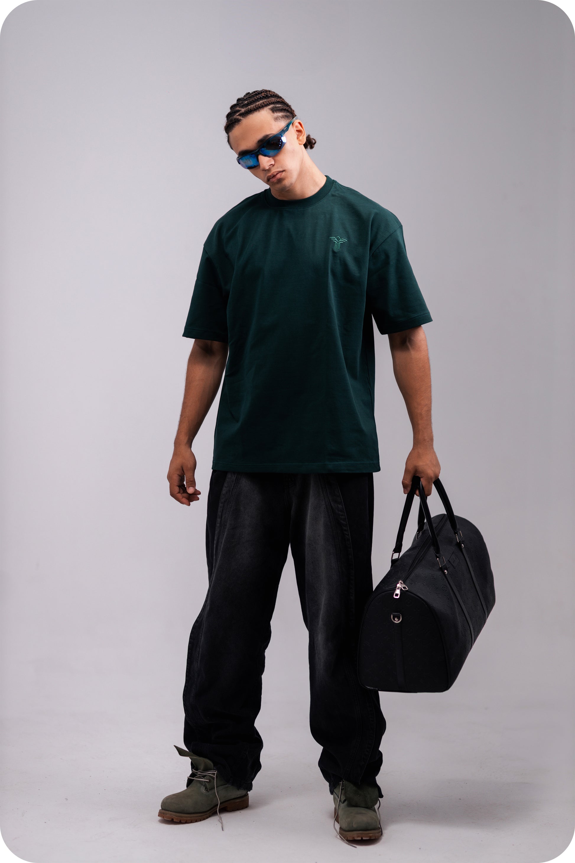 REVER dark-green oversized plain t-shirt side profile highlighting loose fit and minimal cut.