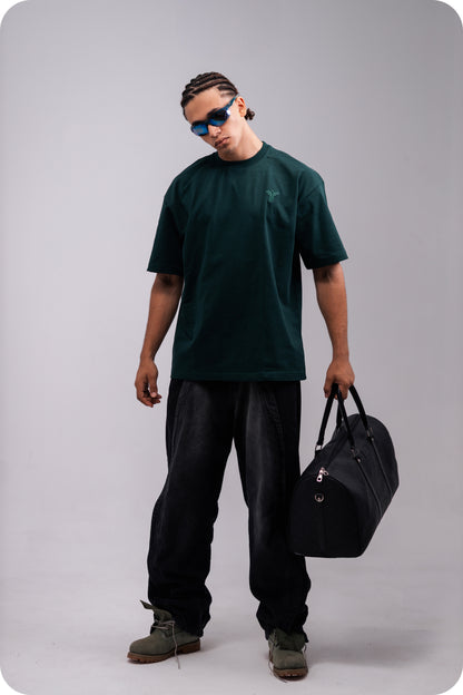REVER dark-green oversized plain t-shirt side profile highlighting loose fit and minimal cut.