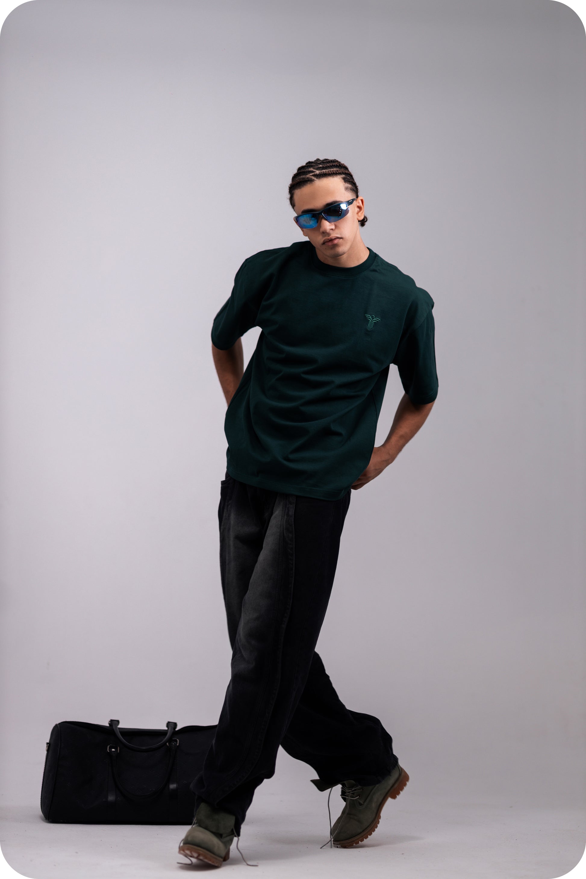 REVER dark-green oversized plain t-shirt side profile highlighting loose fit and minimal cut.