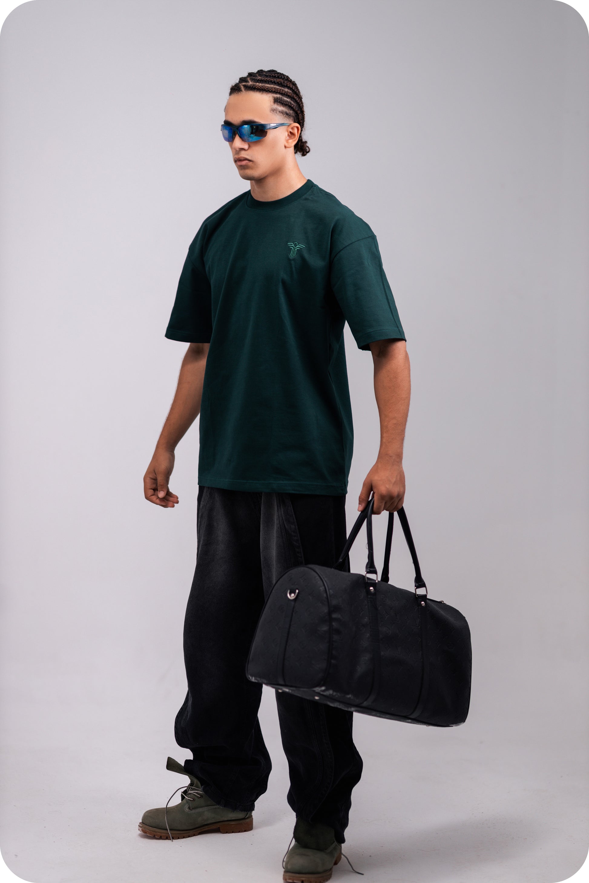 REVER dark-green oversized plain t-shirt side profile highlighting loose fit and minimal cut.