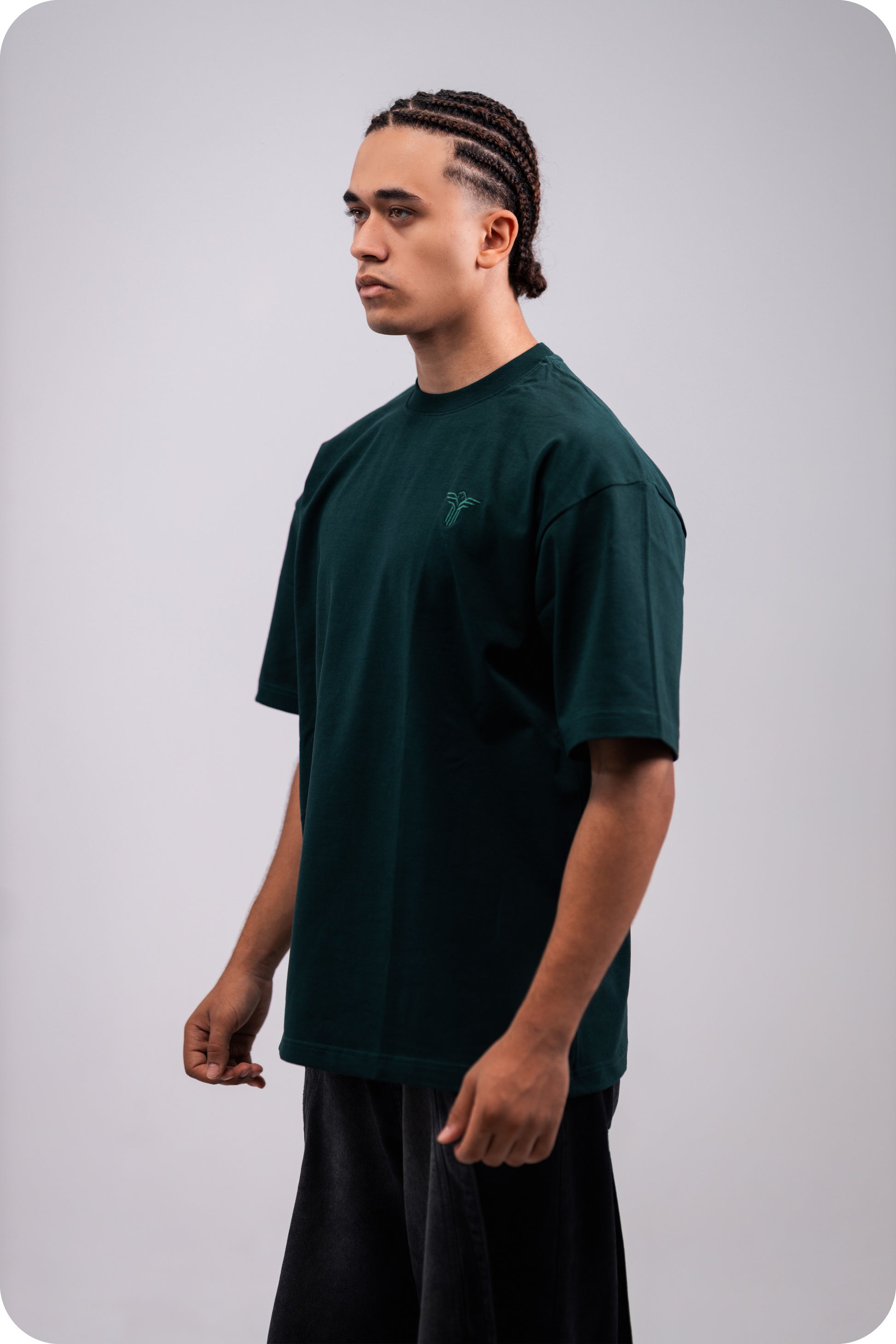 REVER dark-green oversized plain t-shirt side profile highlighting loose fit and minimal cut.