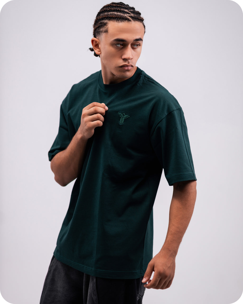 REVER dark-green oversized plain t-shirt side profile highlighting loose fit and minimal cut.