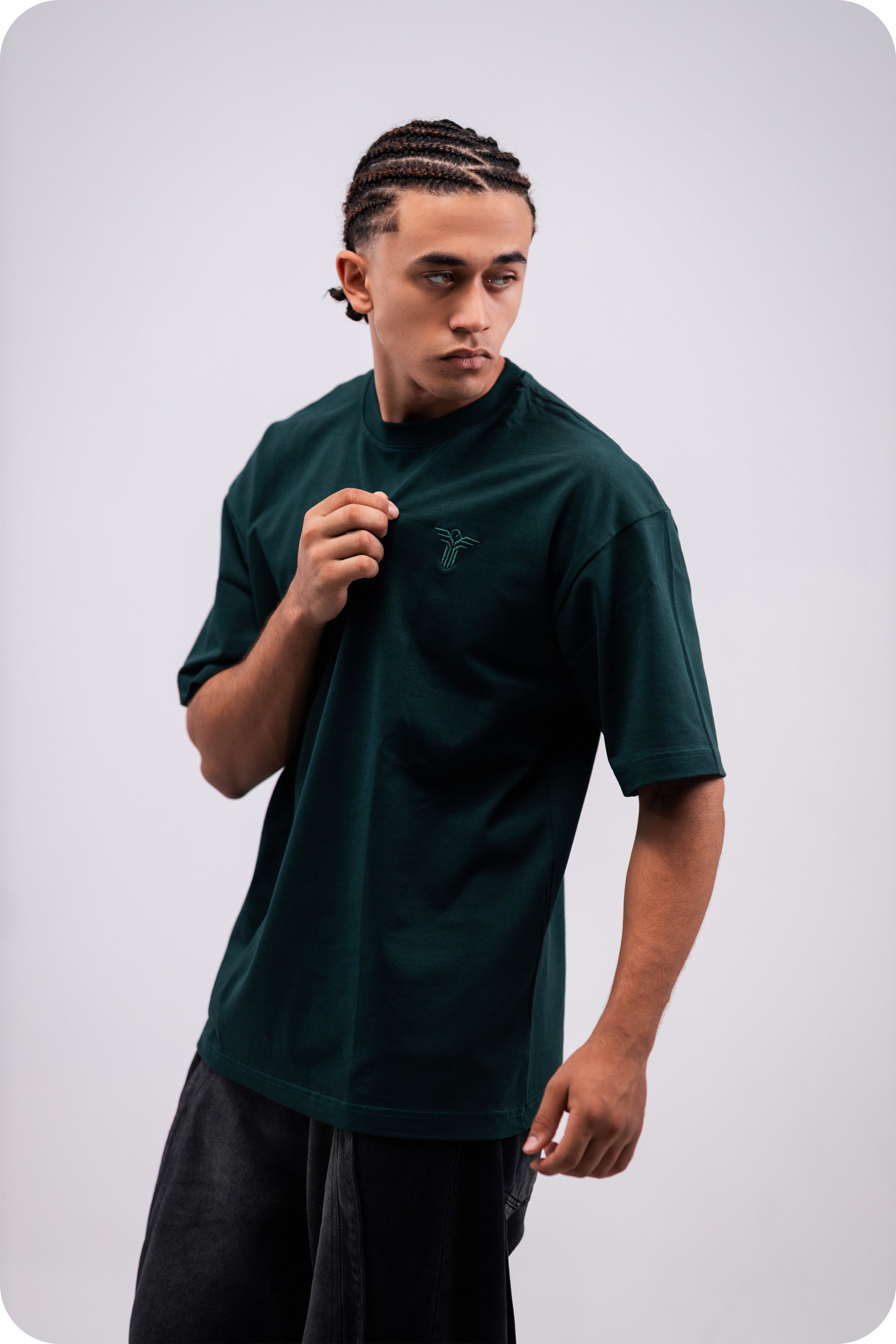 REVER dark-green oversized plain t-shirt side profile highlighting loose fit and minimal cut.