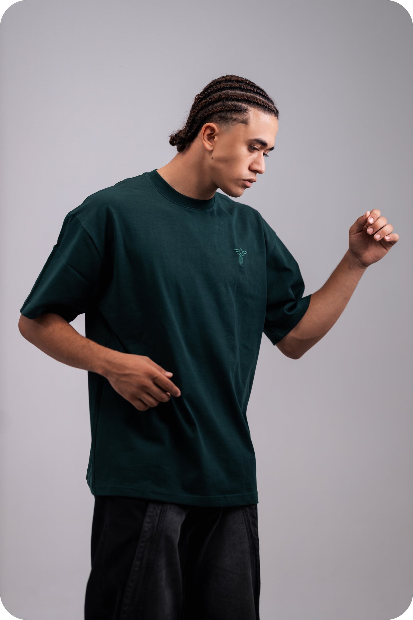 REVER dark-green oversized plain t-shirt side profile highlighting loose fit and minimal cut.