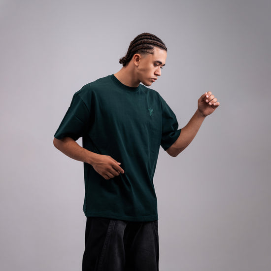 REVER dark-green oversized plain t-shirt side profile highlighting loose fit and minimal cut.