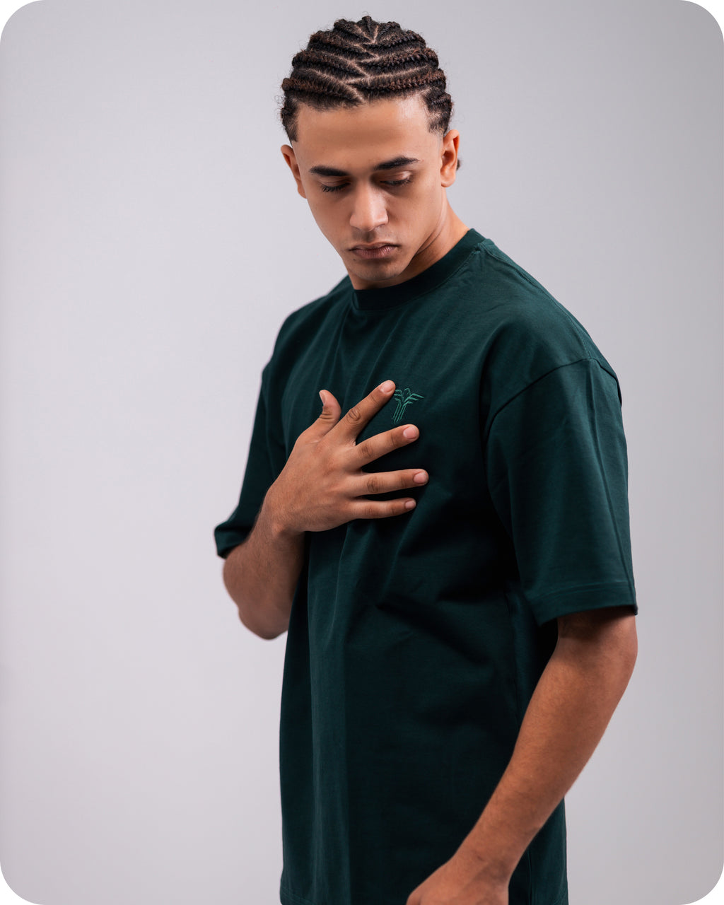 REVER dark-green oversized plain t-shirt side profile highlighting loose fit and minimal cut.