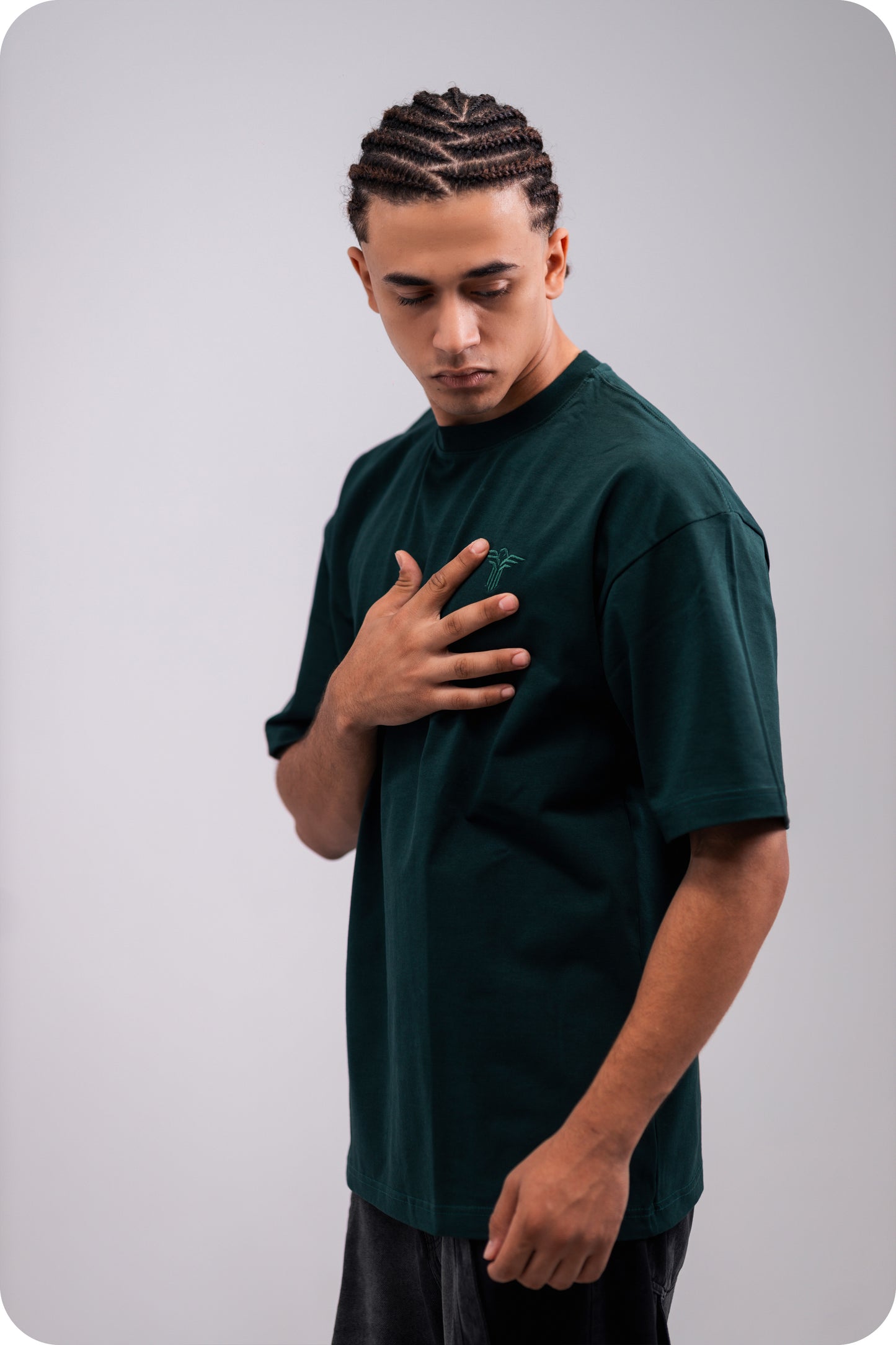 REVER dark-green oversized plain t-shirt side profile highlighting loose fit and minimal cut.