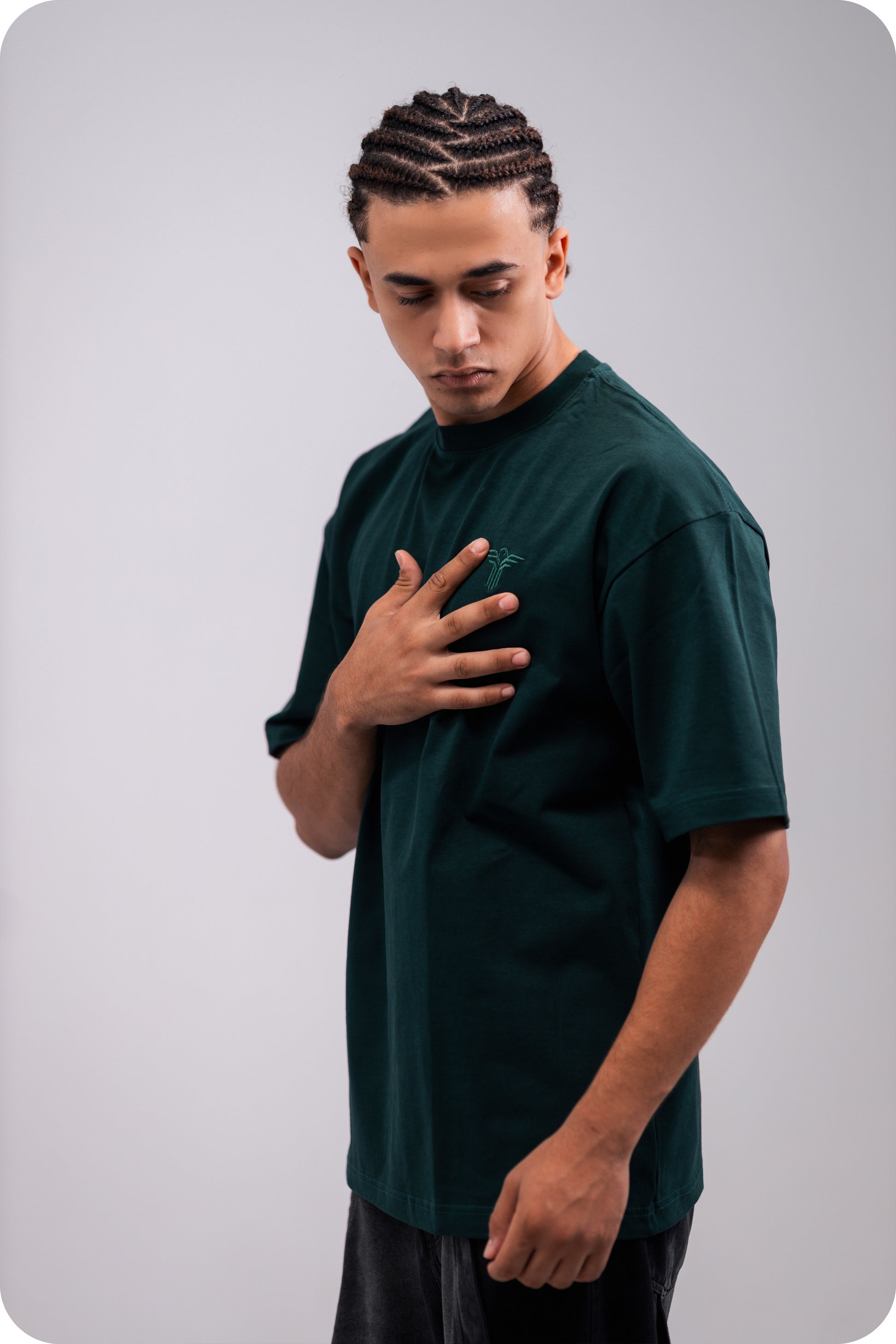 REVER dark-green oversized plain t-shirt side profile highlighting loose fit and minimal cut.