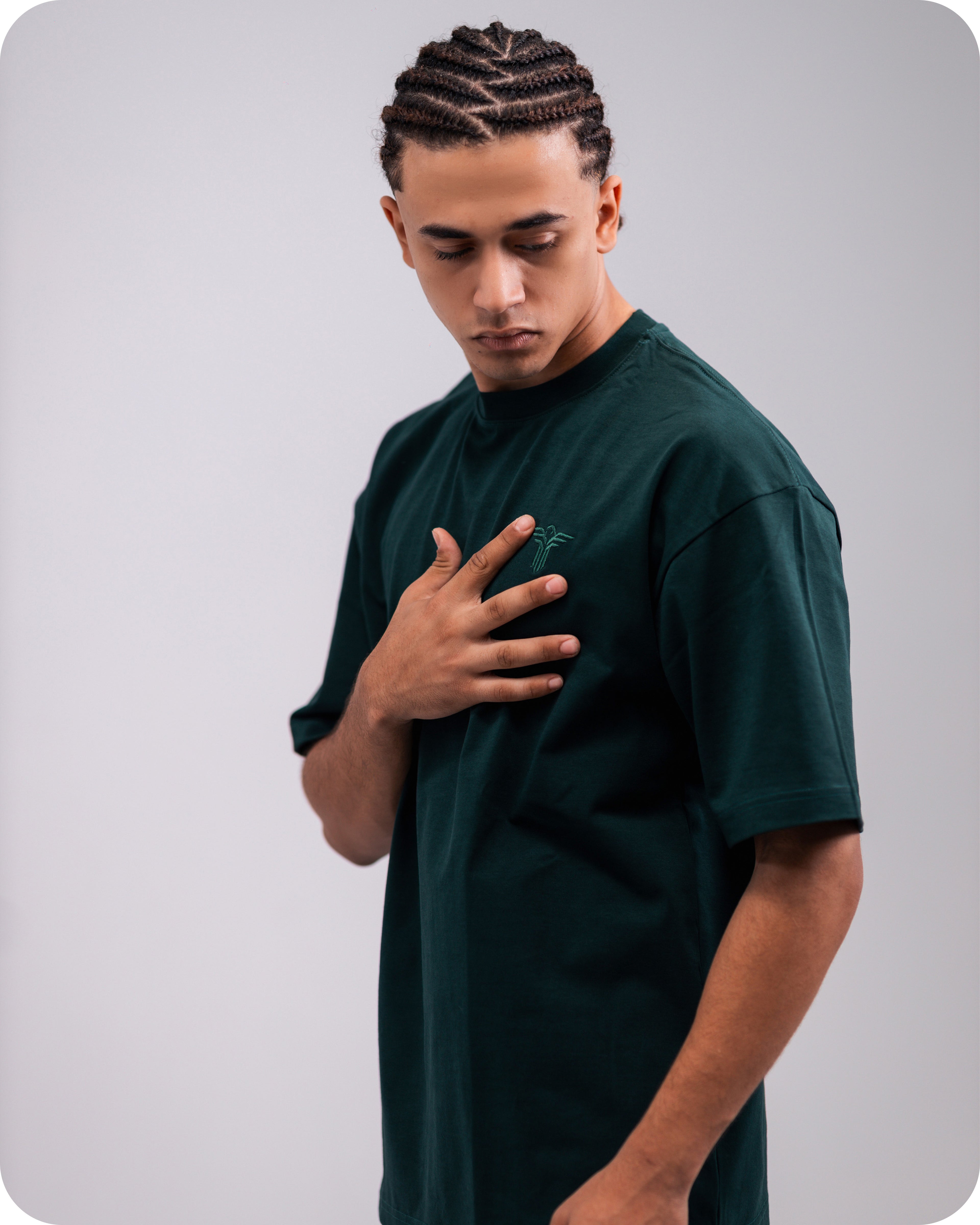 REVER dark-green oversized plain t-shirt side profile highlighting loose fit and minimal cut.