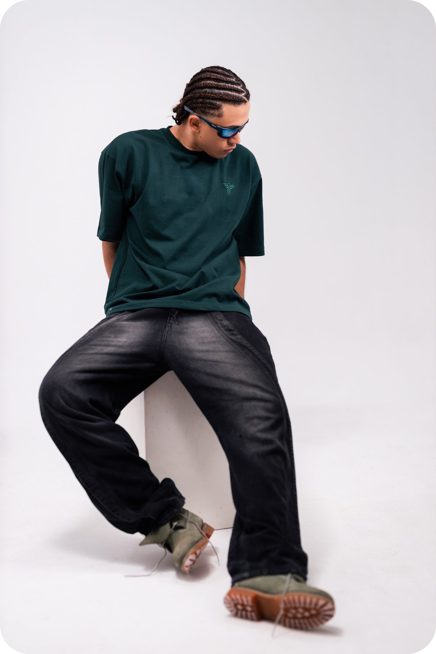 REVER dark-green oversized plain t-shirt side profile highlighting loose fit and minimal cut.