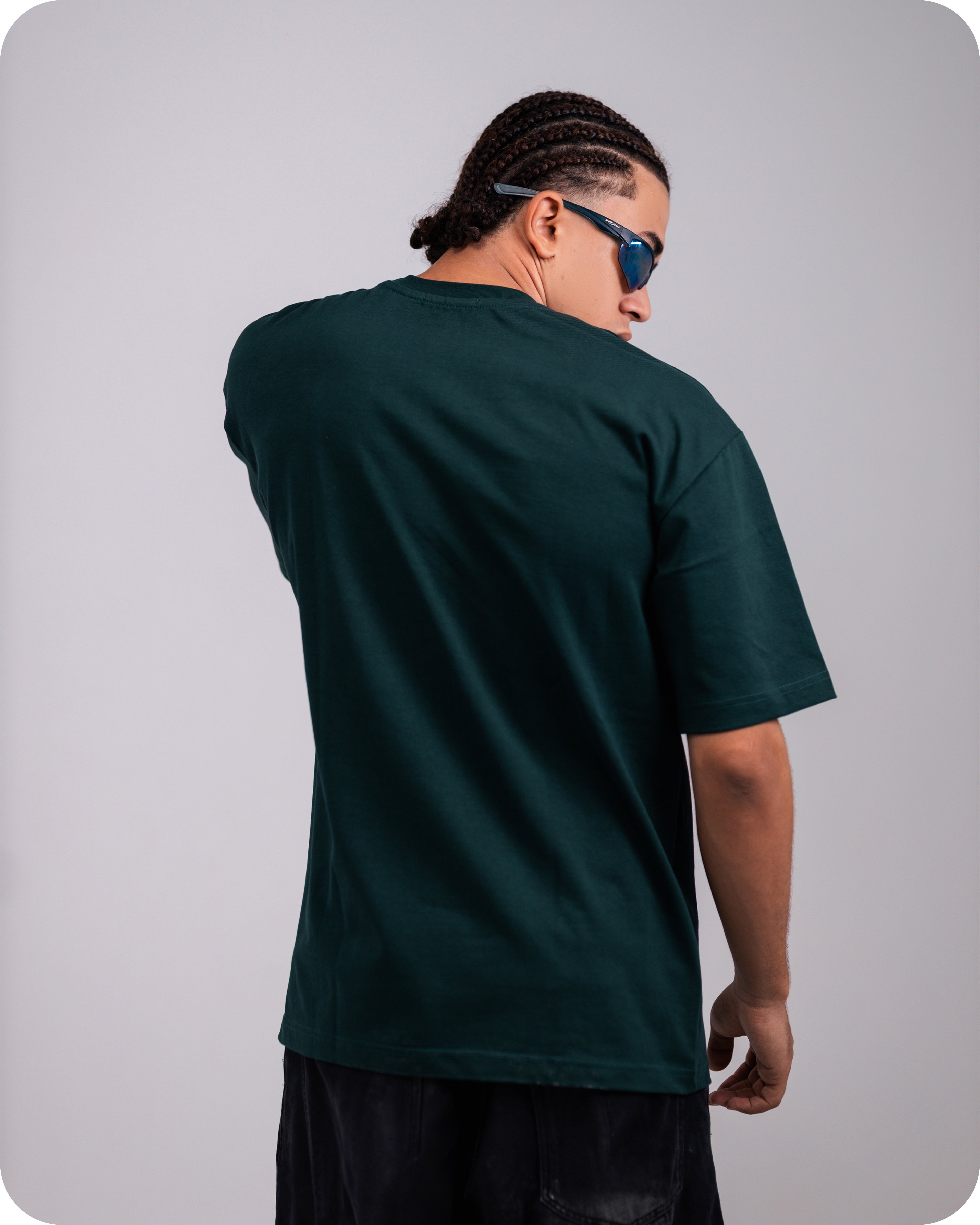 REVER dark-green oversized plain t-shirt side profile highlighting loose fit and minimal cut.