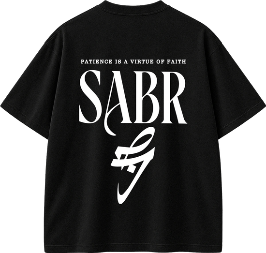 Black short-sleeve t-shirt with a large white graphic print on the back. The design features the text 'PATIENCE IS A VIRTUE OF FAITH' above the word 'SABR' in a stylized serif font, with a white abstract logo underneath.