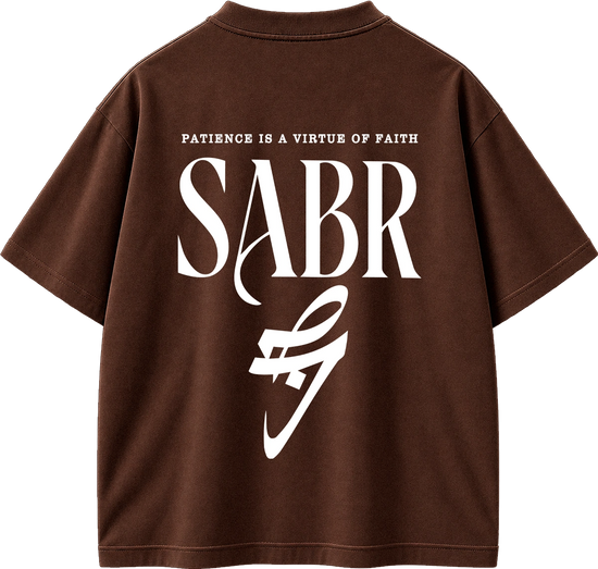 A brown short-sleeve t-shirt shown from the back, featuring a large white graphic print with the text 'PATIENCE IS A VIRTUE OF FAITH' and 'SABR' above a stylized white logo.