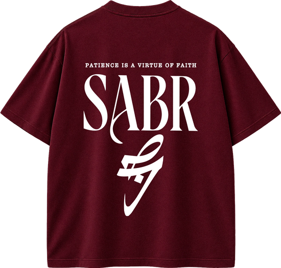 A maroon short-sleeve t-shirt shown from the back, featuring a large white graphic print with the text 'PATIENCE IS A VIRTUE OF FAITH' and 'SABR' in a stylized font.