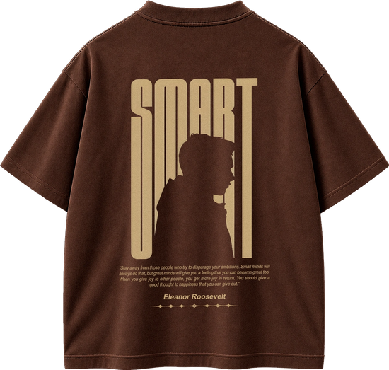 A brown short-sleeve t-shirt shown from the back, featuring a large beige graphic print of the word 'SMART' with a silhouette of a person inside the letters, and a quote attributed to Eleanor Roosevelt below.