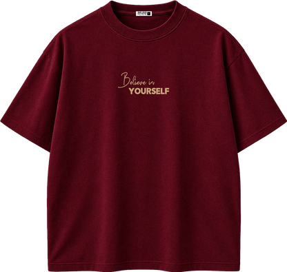 A maroon short-sleeve crewneck t-shirt with 'Believe in YOURSELF' printed in gold on the chest, displayed on a clean white background.
