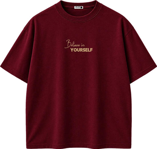 A maroon short-sleeve crewneck t-shirt with 'Believe in YOURSELF' printed in gold on the chest, displayed on a clean white background.